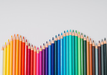 Back to school! Creative layout made of colored pencils on white background. Minimal colored...