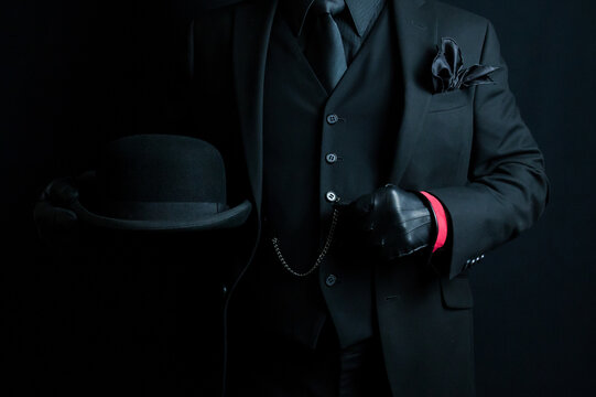 Portrait of Gentleman in Dark Suit Holding Bowler Hat. Mafia Hit Man or Gentleman Gangster.