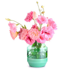Vase with beautiful pink eustoma flowers on white background