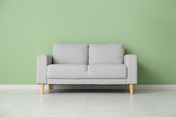 Interior of living room with sofa near green wall
