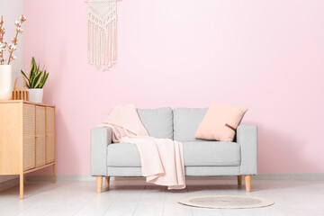 Interior of living room with sofa and chest of drawers