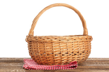 Fototapeta na wymiar Wicker picnic basket and napkin on wooden table against white background