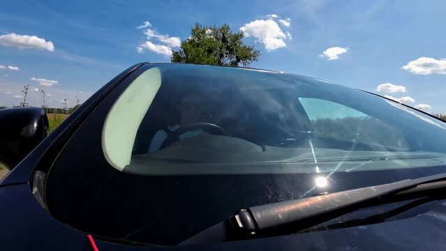 view of driver in front window driving
