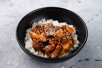Pork with basmati rice, pineapple, sweet pepper, carrot, sesame and sauce.