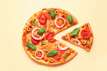 Tasty pizza with olives, tomatoes and basil on yellow background