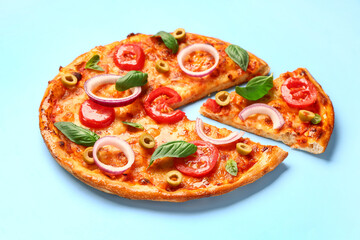 Tasty pizza with olives, tomatoes and basil on blue background