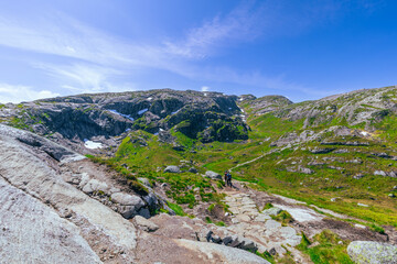Fototapeta premium Kjerag, Norway - July 5th, 2023: The epic mountain landscape on the famous Kjerag hike in southern Norway