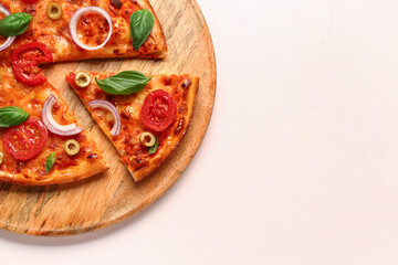 Board with tasty pizza on beige background