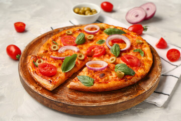 Wooden plate with tasty pizza and ingredients on grunge grey background
