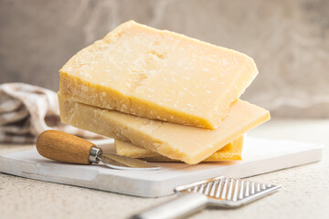 Tasty parmesan cheese on kitchen table.