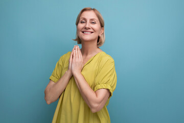 calm middle aged woman put her hands together for prayer