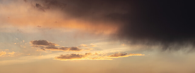 Dark storm cloud in a dramatic sky during sunset
