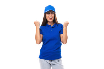 joyful pretty young brunette woman in blue cap and t-shirt with print mockup on white background with copy space