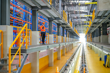 Engineers inspecting locomotive in railway engineering facility