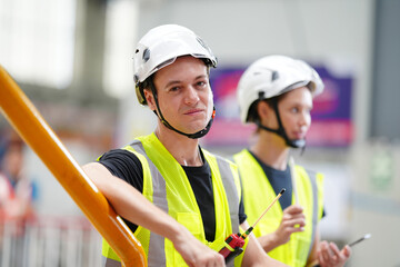 Engineers inspecting locomotive in railway engineering facility