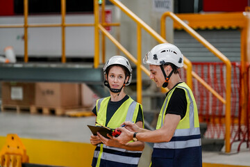 Engineers inspecting locomotive in railway engineering facility