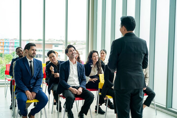 Fototapeta premium conference meeting. Business people sitting in a room listening to the motivator coach. Representation of a Self-growth and improvement special event