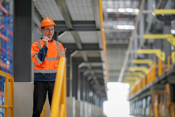 Engineers inspecting locomotive in railway engineering facility