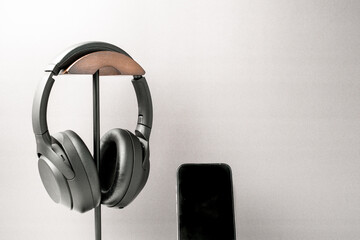 Headphone and smart phone for podcast, music, listening. Black and white with copy space