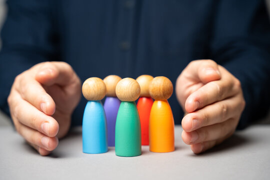 Boss defending his team with a gesture of protection.Security and safety in a business team concept. Life insurance. Customer care, care for employees. Human resources. Social protection.