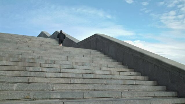 Male athlete running by stairs outdoors during workout. Sport Motivation. 40s Male Athlete Running Up On Urban Stairs Outdoors, Enjoying Morning Workout With Free Space