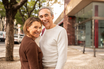 Smiling Senior Couple In Casual Outfit Standing On Street Outdoors