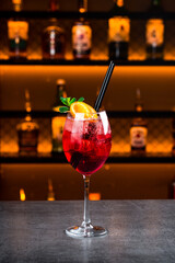 Martini Fiero cocktail with champagne, orange juice and ice on the bar counter.