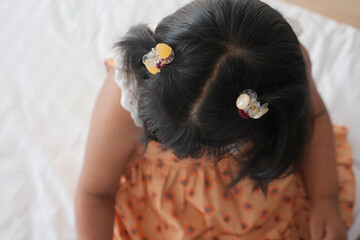 Beautiful ribbon is tied on a child hair 