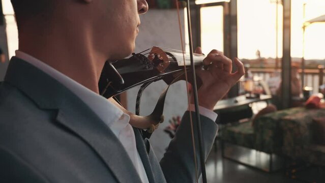 Violinist play violin in bar or restaurant close up, musical performance.