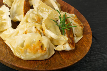 Gyoza Chinese Dumplings on Wood Plate, Fried Vegetable Jiaozi Macro, Chicken Momo Pile, Asian Gyoza Closeup