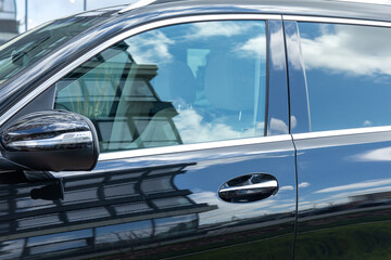 Closeup photo of a new car door. Car rental concept. Modern luxury car close-up on banner...