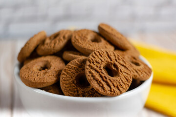 Ring chocolate biscuits served in a bowl. Brazilian little donut. Selective focus.	