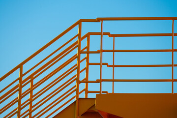 Yellow metal hand railings on a ferry.