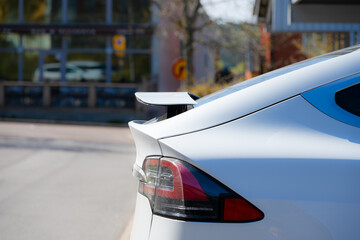 Rear wing of a white aerodynamic car.