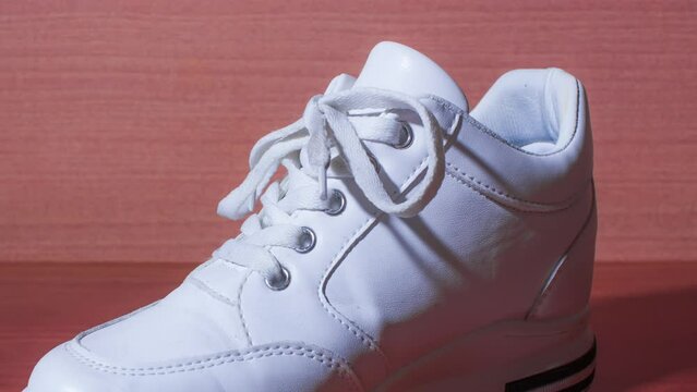White shoe ties shoelaces in stop motion