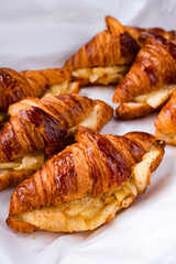 Breakfast fresh croissants with with baked pear and cinnamon, closeup.