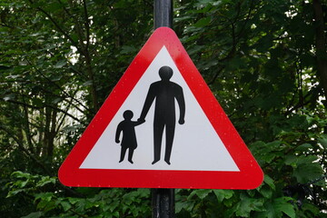 Caution sign for pedestrians on road due to no walkway.  People on road warning sign for motorists 