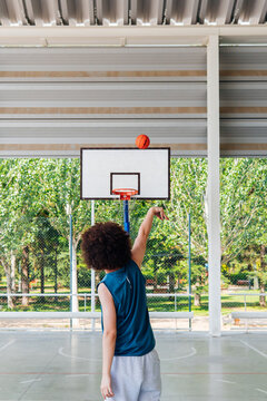 Amateur basketball player shooting a three-pointer on a city court
