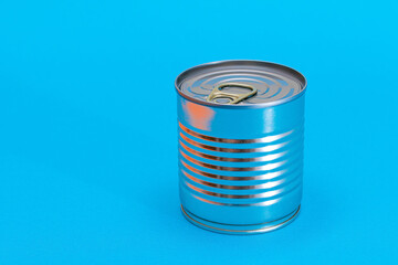 Unopened Tin Can with Blank Edge on Light Blue Background. Canned Food. Aluminum Can for Safe and Long Term Storage of Food. Steel Sealed Food Storage Container