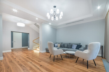 Elegant interior of a luxurious mansion in bright colors. Parquet floor, stylish lamps, .designer furniture.