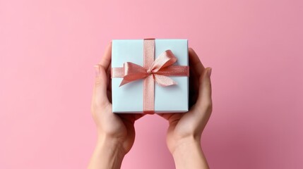 Close-up of female hands holding a small gift, surprise gift box. Small gift in hand. focus on the small box.