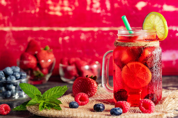 Berry cooling cocktail in a glass jar close-up. Copy space.