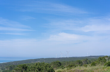 Wind farm on the coast of the Atlantic Ocean in Nazare in Portugal. Windmills on the hills.