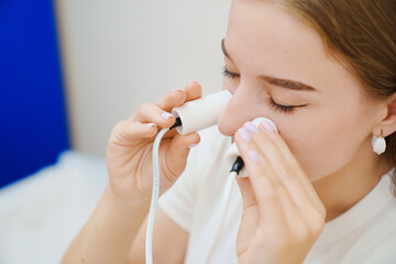 A patient on a magnetotherapy procedure on the nose