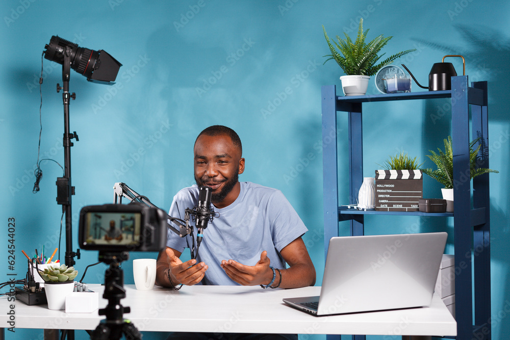 Poster blogger using camera and microphone for live streaming on social media channel. african american vid