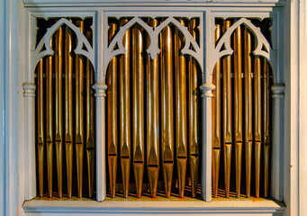 Details from a big old church organ. Music instrument made out of metal pipes