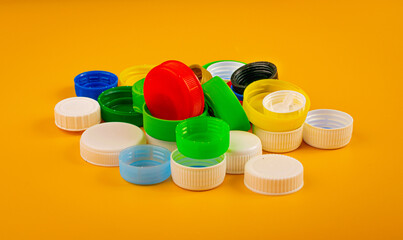 Plastic Bottle Caps Pile. Recycling HDPE Material Group, Circle Polyethylene Lid Set, Colorful Caps...