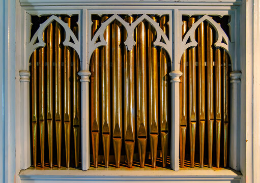 Details from a big old church organ. Music instrument made out of metal pipes