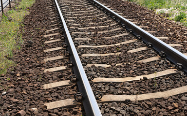 Naklejka premium Railway Lines Closeup, Train Tracks with Track Ballast Stones, Metal Rails, Old Railway Track