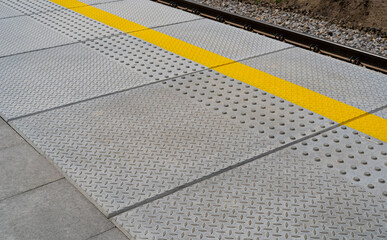 Fototapeta premium Tactile Paving on Modern Tiles Pathway for Blind Handicap, Safety Sidewalk Walkway for Disability People
